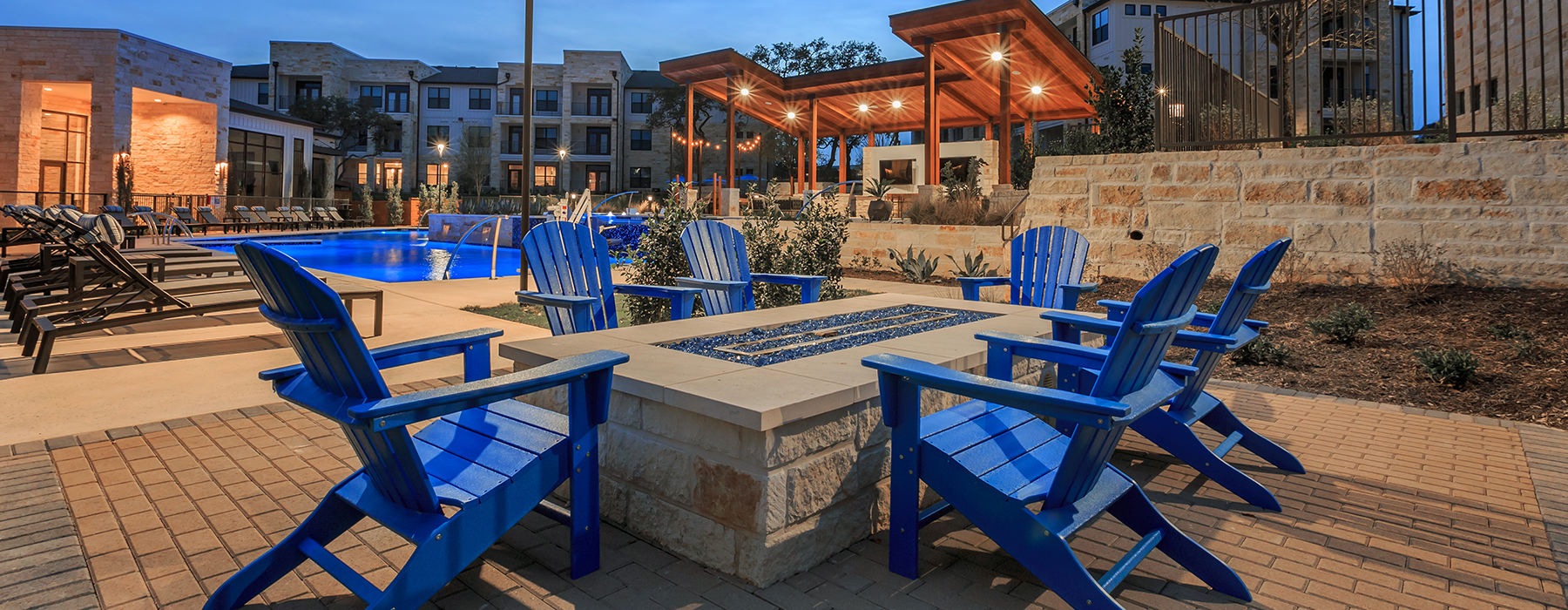 Firepits near the sparkling pool with ample seating